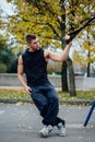 TRX training. Man Instructor at the park doing Excersise. Fitness workout. Royalty Free Stock Photo