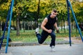 TRX training. Man Instructor at the park doing Excersise. Fitness workout. Royalty Free Stock Photo