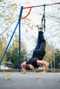 TRX training. Man Instructor at the park doing Excersise. Fitness workout. Royalty Free Stock Photo