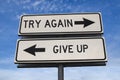 White two street signs with arrow on metal pole with word try again and give up Royalty Free Stock Photo