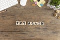 Try Again, Wooden cube with a Try Again message placed on an old wooden desktop Royalty Free Stock Photo
