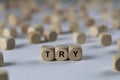 Try - cube with letters, sign with wooden cubes