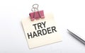 TRY HARDER text on the sticker with pen on the white background Royalty Free Stock Photo