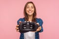 Try on innovative VR glasses! Portrait of beautiful smiling gamer girl giving virtual reality headset to camera Royalty Free Stock Photo