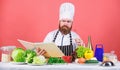 Try something new. Cookery on my mind. Cooking skill. Book recipes. According to recipe. Man bearded chef cooking food Royalty Free Stock Photo