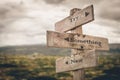 Try something new text on wooden rustic signpost outdoors in nature/mountain scenery.