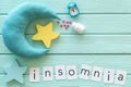 Insomnia concept with moon, stars, alarm clock and pills on mint green wooden background top view Royalty Free Stock Photo