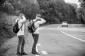 Try to stop some car. Travel and transport concept. Twins men at edge of road nature background. Reason people pick up Royalty Free Stock Photo