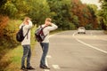 Try to stop some car. Travel and transport concept. Twins men at edge of road nature background. Reason people pick up Royalty Free Stock Photo