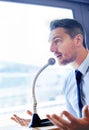 Trying to get his point across...a man in a shirt and tie speaking into a microphone. Royalty Free Stock Photo