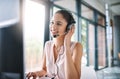 Trying to help as much as she can. an attractive young woman working in a call center. Royalty Free Stock Photo