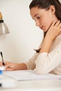 Trying to remember it all. a teenage girl studying at her desk at home. Royalty Free Stock Photo