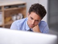 Trying to solve a problem. a handsome young businessman working in his office. Royalty Free Stock Photo