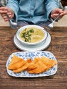 Trying to use fork and spoon to eat meal. kind of Indian food made of flour , Roti with Green Curry Chicken on white plate Royalty Free Stock Photo