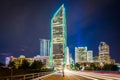 Tryon Street and modern skyscrapers at night, in Uptown Charlotte, North Carolina.