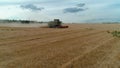 Trypillya, Ukraine - July 15, 2022: Combine harvester in the field. Harvest season. Aerial following footage view