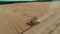 Trypillya, Ukraine - July 15, 2022: Combine harvester in the field. Harvest season. Aerial following footage view