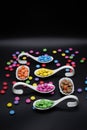 tryspoon for bithday buffet or party with smarties in many different colors on black background