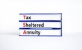 TSA, tax sheltered annuary symbol. Concept words TSA, tax sheltered annuary on books. Beautiful white table, white background,