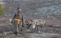 Tsaatan man, dressed in a traditional deel, with his reindeers