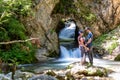 Tscheppaschlucht - Family standing on rock with scenic view of majestic waterfall cascade of Bodentaler Felsentor