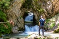 Tscheppaschlucht - Man standing on rock with scenic view of majestic waterfall cascade of Bodentaler Felsentor
