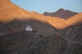 Tsemo Maitreya Temple, Tsemo Goenkhang protector temple as seen  against mountains and blue sky at sunset from Shanti Stupa Royalty Free Stock Photo