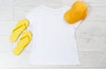 Tshirt mock up empty yellow cap summer flip flops top view copy space mock up Royalty Free Stock Photo