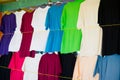 Tshirts hang in local shop or market in castries, st.lucia. Colorful clothes on sale. Sale, shopping and purchase. Black Friday an Royalty Free Stock Photo