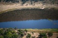 TSHWAING METEORITE IMPACT CRATER WITH SURROUNDING SLOPING AREAS AND WATER AT THE BOTTOM Royalty Free Stock Photo