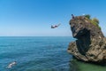 Tsikhisdziri, Georgia - 07 August, 2020: Man jumping from high rock to the see