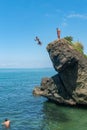 Tsikhisdziri, Georgia - 07 August, 2020: Man jumping from high rock to the see