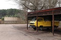 An old yellow Volkswagen (VW) delivery car parked in a garage