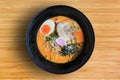 Tsukemen Ramen Asian noodles with chashu Pork, seaweed and boiled egg in black bowl on bamboo wooden background, top view Royalty Free Stock Photo