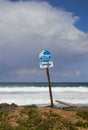 A tsunami sign at a beach on a cloudy day at Puerto Rico. Royalty Free Stock Photo