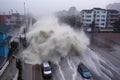 tsunami wave crashes into coastal town, flooding buildings and washing away cars