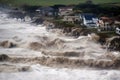 tsunami waves crash onto shore and breach coastal dikes, causing flooding and destruction