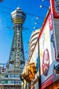 OSAKA, JAPAN - JUNE 20, 2019 :: Tsutenkaku tower located in the Shinsekai, well-known landmark of Osaka. Famous shopping streets i