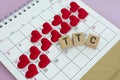 TTC word on wooden block with red heart shape on calendar. Trying To Conceive.