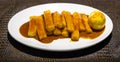 Tteok bokki on white plate on leathed board