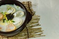 tteok mandu guk, Korean style dumpling soup with sliced rice cake Royalty Free Stock Photo