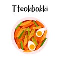 Tteokbokki, isolated stir-fried rice cakes with boiled eggs in a white bowl. Close up top view Asian food. Korean Royalty Free Stock Photo