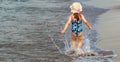 Ittle girl running on the sea beach