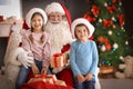 Little children receiving gifts from authentic Santa Claus Royalty Free Stock Photo