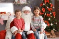 Little children sitting on authentic Santa Claus` knees Royalty Free Stock Photo