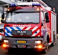 Ttruck of the fire brigade in The Netherlands called Brandweer in red car with blue and white striping.