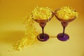 TTwo glasses with paper straws stand on a yellow isolated background. Royalty Free Stock Photo