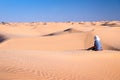 Tuareg man sitting in the Sand dunes desert of Sahara Royalty Free Stock Photo