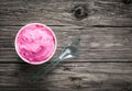 Tub of berry ice cream on a rustic wood table Royalty Free Stock Photo