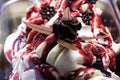 Tub of cream ice cream and strawberry syrup with chocolate flowers in artistic way in an Italian ice cream shop to refresh Royalty Free Stock Photo